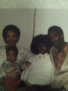 To the far right, my mother Doris. On her lap is my baby brother, Maurice. Next to him is me (Felecia) with the Jerry Curl. My father on the end. he died at age 50 of a heart attack.